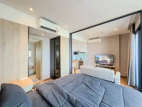 1 Bedroom Condo for Rent at Once Pattaya open-plan bedroom with living area, TV, and kitchenette