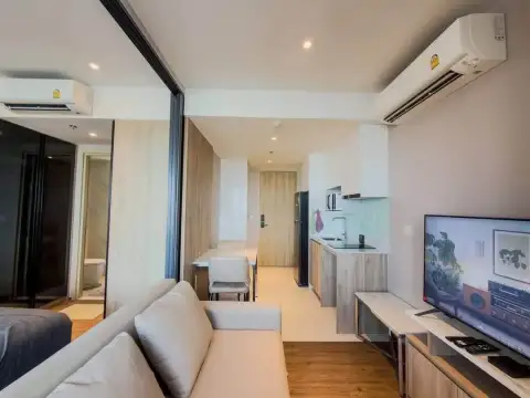 1 Bedroom Condo for Rent at Once Pattaya living room with sofa, dining table, and kitchen area