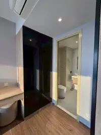 2 Bedroom Condo for Sale at Once Pattaya hallway with black glossy wardrobe and view into marble bathroom
