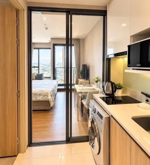 Studio Condo for Rent at Once Pattaya kitchenette with washing machine and view to bedroom