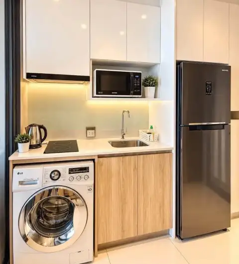 Studio Condo for Rent at Once Pattaya compact kitchen with washer, microwave, and fridge