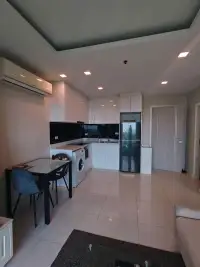 1 Bedroom Condo for Rent at One Tower Pratumnak kitchen and dining area with washing machine and black fridge