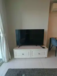1 Bedroom Condo for Rent at One Tower Pratumnak flat-screen TV on white cabinet beside balcony window