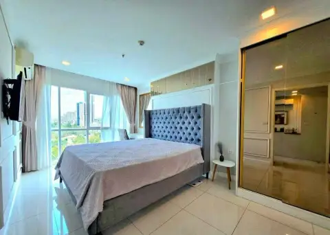 1 Bedroom Condo for Sale at One Tower Pratumnak bedroom with tufted headboard and mirrored closet