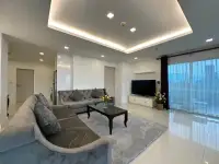 2 Bedroom Condo for Rent at One Tower Pratumnak open living area with gray sofas, TV and city view