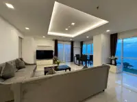 2 Bedroom Condo for Rent at One Tower Pratumnak spacious lounge with dining area and ocean view windows