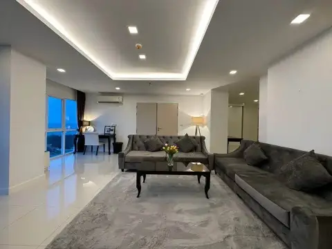 2 Bedroom Condo for Rent at One Tower Pratumnak cozy living room with sectional sofa and evening lighting