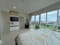 1 Bedroom Condo for Sale at One Tower Pratumnak bedroom with TV console and city view windows