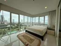 1 Bedroom Condo for Sale at One Tower Pratumnak bedroom with floor-to-ceiling windows overlooking ocean and skyline