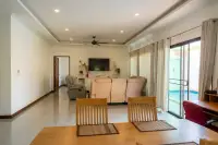 3 Bedroom House for Sale at Siam Executive Estate hallway view of lounge with dining chairs and pool access
