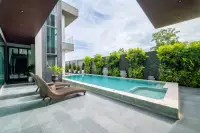 5 Bedroom House for Sale at Opal Village outdoor swimming pool with lounge chairs and tropical landscaping