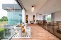 5 Bedroom House for Sale at Opal Village upstairs lounge area with floor-to-ceiling windows and wood flooring