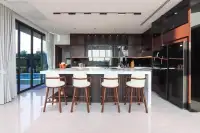 5 Bedroom House for Sale at Opal Village modern kitchen with marble island and bar stools