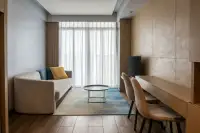 1 Bedroom Condo for Rent at Beverly Mountain Bay Pattaya living room with beige sofa, blue rug, and wood desk
