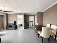 2 Bedroom Condo for Sale at The Orient Resort & Spa living and dining area with TV cabinet and view into bedroom and bathroom