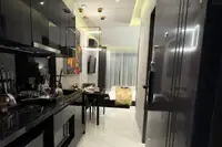 Studio Condo for Sale at Grand Solaire Noble: View from entrance showing kitchenette, dining table, and bedroom area.