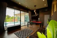 4 Bedroom House for Rent in Bang Lamung interior game room with red pool table, wood flooring, and pool view