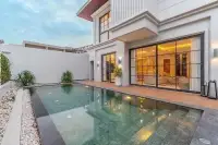 3 Bedroom House for Sale in Huai Yai private pool with wood deck and large glass sliding doors at twilight