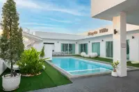 5 Bedroom House for Sale in Huai Yai private pool with water slide, green lawn, and white modern exterior daytime