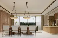 4 Bedroom House for Sale at Solava Pattaya elegant dining room with pendant lights, wood accent wall, and garden views