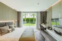 Studio Condo for Sale at The Coral Pattaya: Bedroom looking towards the modern kitchen and living area.