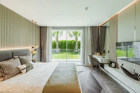 Studio Condo for Sale at The Coral Pattaya: Bedroom looking towards the modern kitchen and living area.