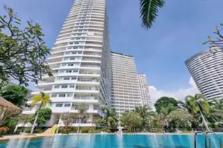 View Talay 7 tall white condominium building exterior with a large swimming pool in the foreground.