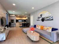4 Bedroom House for Sale at Palm Spring villa Pattaya open-plan living room with Japanese wave fan art and grey sofa