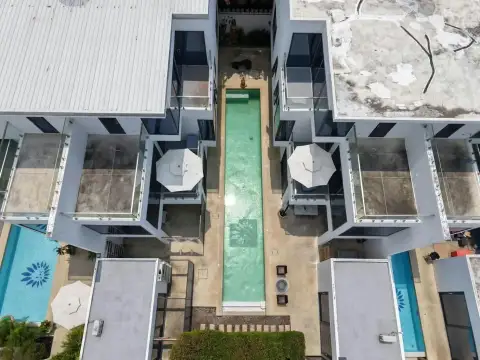 4 Bedroom House for Sale at Palm Spring villa Pattaya top-down drone view of narrow pool between villa buildings
