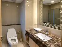 Studio Condo for Rent at Palm Wongamat bathroom with marble vanity and glass shower
