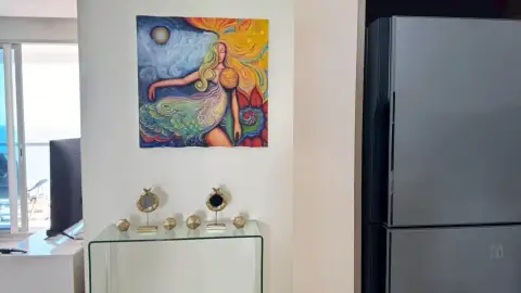 2 Bedroom Condo for Rent at Palm Wongamat kitchen corner with colorful wall art and refrigerator