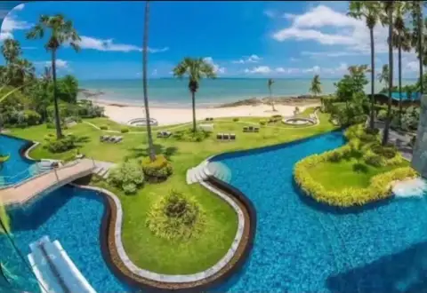 2 Bedroom Condo for Rent at Palm Wongamat curved swimming pool overlooking the beach and sea