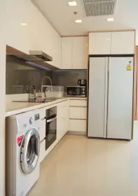 2 Bedroom Condo for Rent at Palm Wongamat modern kitchen with built-in oven, fridge and washing machine
