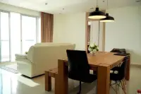 2 Bedroom Condo for Rent at Palm Wongamat dining area with wooden table and bench near balcony