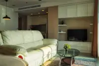 2 Bedroom Condo for Rent at Palm Wongamat living room with cream leather sofa and wall-mounted TV