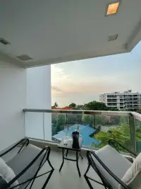 2 Bedroom Condo for Sale at Palm Wongamat balcony seating area with sea view at sunset