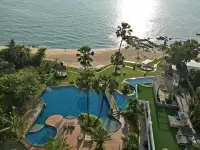2 Bedroom Condo for Sale at Palm Wongamat aerial view of curved lagoon pool with beach and sea access