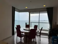 3 Bedroom Condo for Sale at Palm Wongamat dining area with round table and panoramic sea view