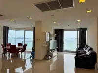 3 Bedroom Condo for Sale at Palm Wongamat open-plan living and dining space with floor-to-ceiling sea views