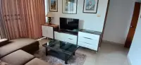2 Bedroom Condo for Sale at Panchalae Boutique Residence living room with sofa, TV console, and glass coffee table