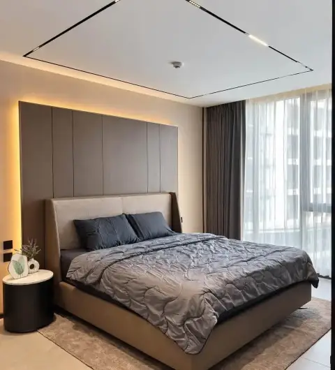 1 Bedroom Condo for Rent at Panora Estuaria master bedroom with upholstered bed and sheer curtains