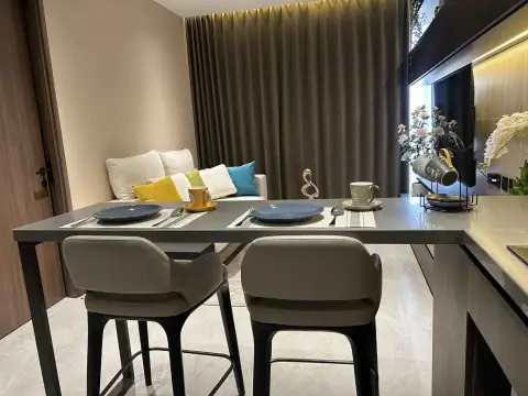 1 Bedroom Condo for Rent at Panora Estuaria dining counter set with tableware beside kitchen and lounge