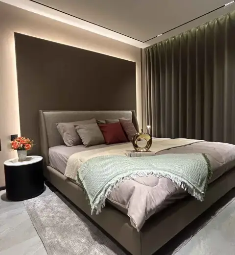 1 Bedroom Condo for Rent at Panora Estuaria bedroom with upholstered bed and ambient wall lighting