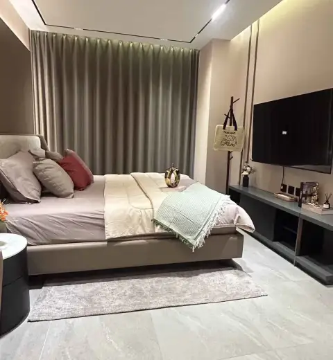 1 Bedroom Condo for Rent at Panora Estuaria bedroom view with bed, TV console, and decor accents
