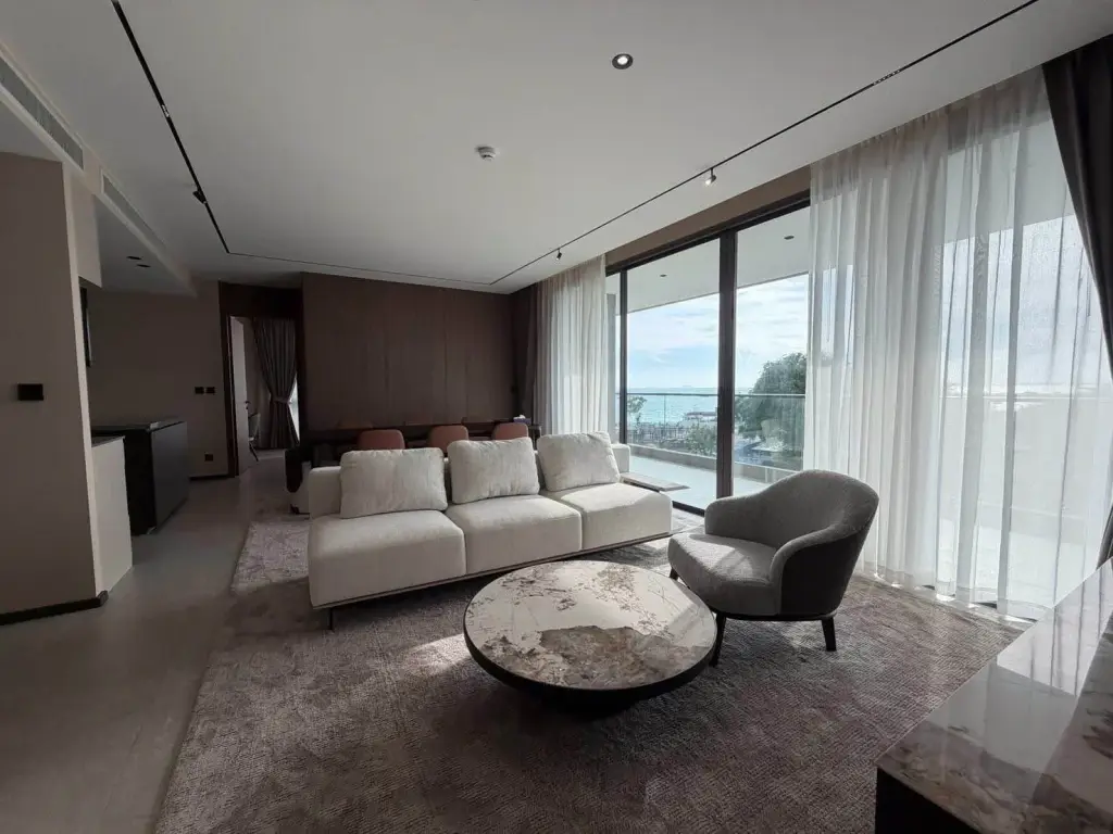 3 Bedroom Condo for Rent at Panora Estuaria living room with sofa, round coffee table and sea view balcony