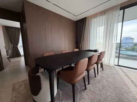 3 Bedroom Condo for Rent at Panora Estuaria dining room with black table, leather chairs and balcony access