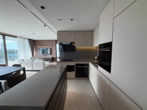 3 Bedroom Condo for Rent at Panora Estuaria modern kitchen with island counter and built-in appliances overlooking living area