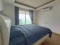 2 Bedroom Condo for Sale at Paradise Ocean View bedroom with leather headboard and sliding door to sea view balcony