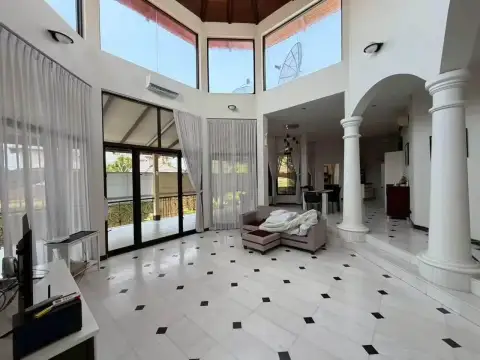 5 Bedroom House for Rent at Paradise Villa 1 & 2 double-height living room with large windows and balcony access