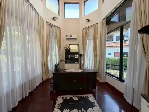 5 Bedroom House for Rent at Paradise Villa 1 & 2 sunroom study with wooden desk and floor-to-ceiling windows